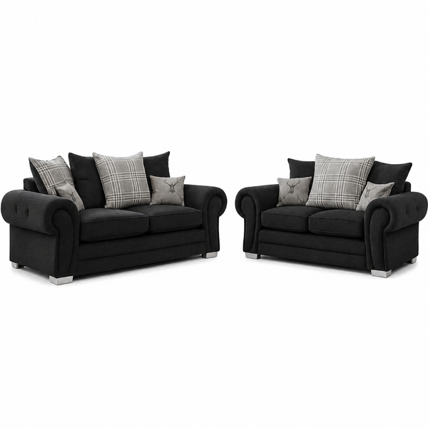 A two-piece black fabric sofa set consisting of a loveseat and a single-seater armchair, both styled with gray plaid and solid accent pillows, set against a plain white background.