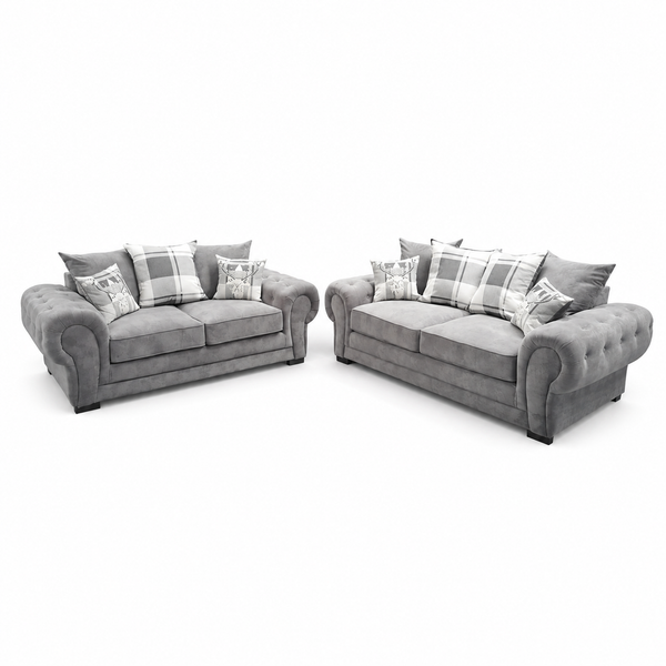 A gray upholstered loveseat and matching armchair set with plaid accent pillows, shown on a plain white studio background.